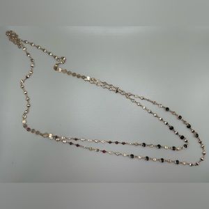 Gold and black layered necklace.